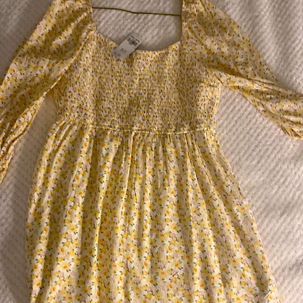 A beautiful yellow flower dress with a cute spice with off and on the shoulder.